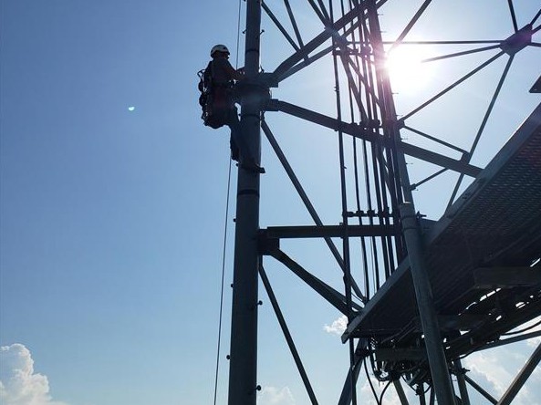 Person Climbing Cell Tower